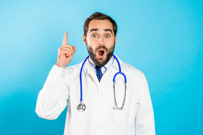 Man standing against blue background