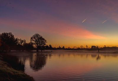 Scenic view of lake against sky during sunset