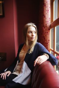 Young woman sitting at home