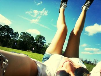 Low section of woman relaxing on tree