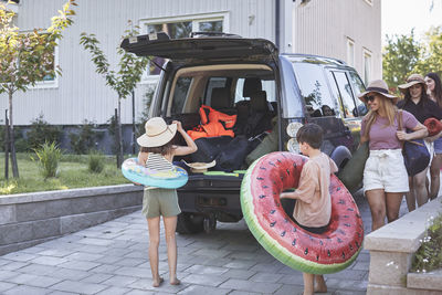 Family packing car before holiday