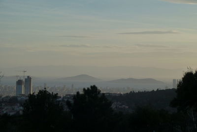 Scenic view of mountains against sky at sunset