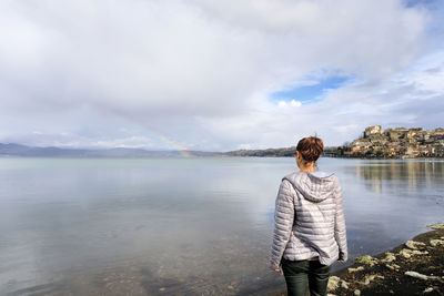  woman looking at view of sea against sky