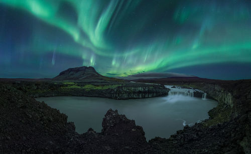 Scenic view of mountain against sky at night