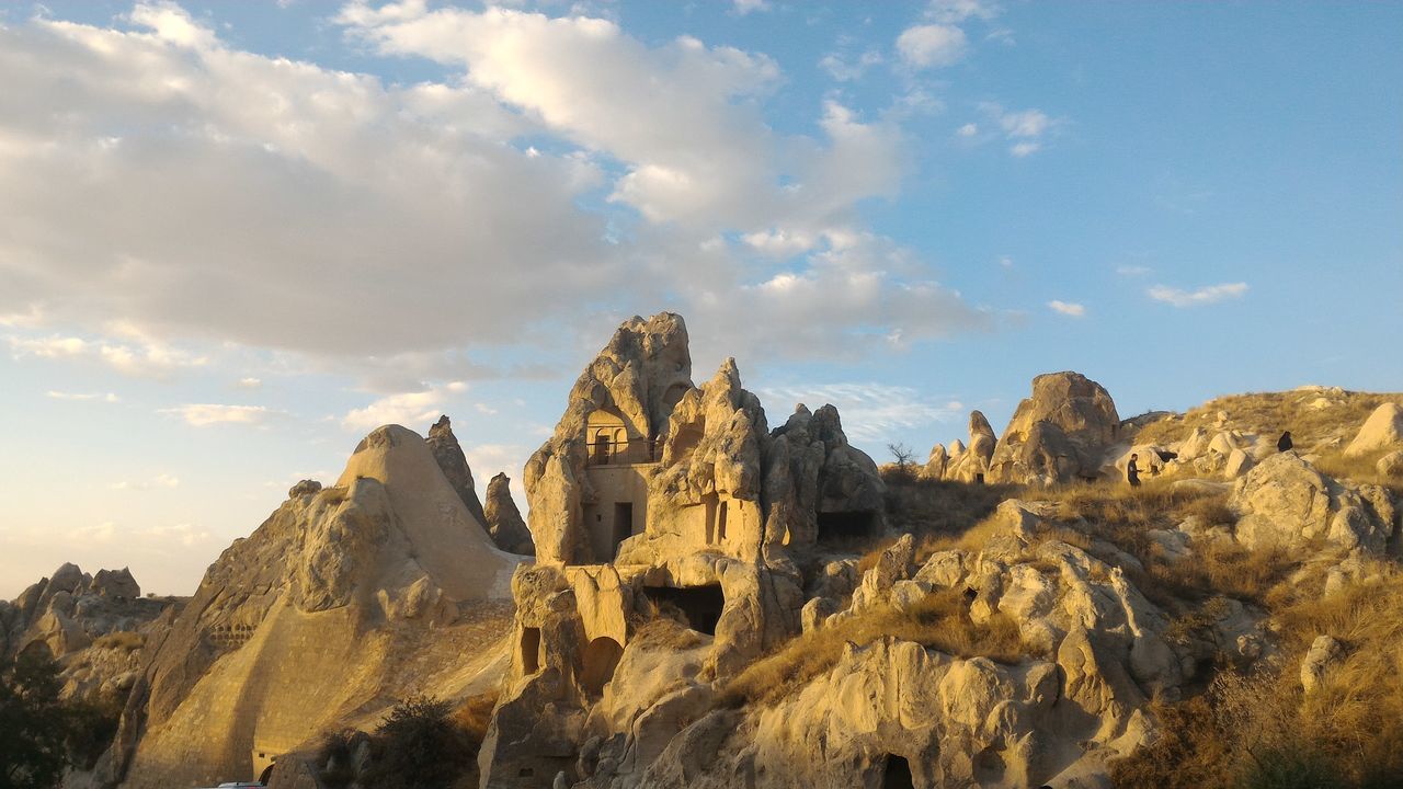 sky, rock formation, tranquility, rock - object, scenics, tranquil scene, low angle view, nature, cloud - sky, beauty in nature, mountain, physical geography, geology, blue, rocky mountains, cloud, eroded, day, travel destinations, landscape