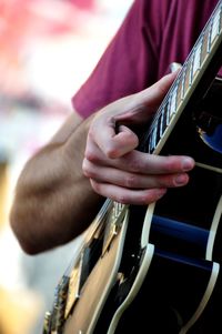 Close-up of man playing guitar