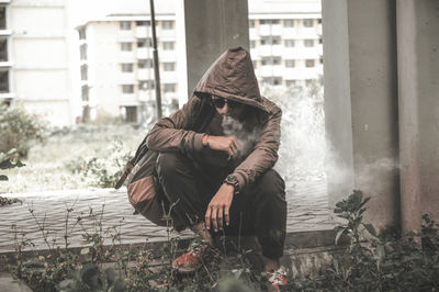 People sitting on snow covered buildings in city