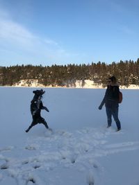 Man standing on snow field against sky