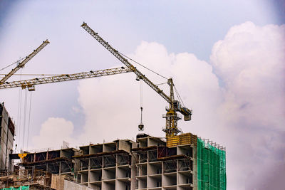 Low angle view of crane against sky