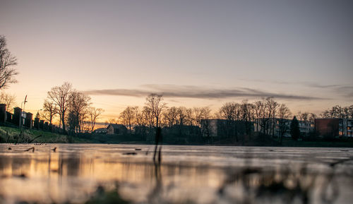 Scenic view of lake against sky at sunset