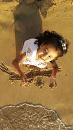 High angle portrait of girl playing at beach