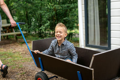 Smiling boy sitting n cart