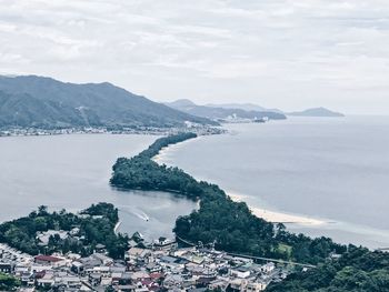 Scenic view of sea and mountains against sky