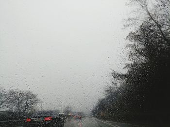 Close-up of wet car window during rainy season