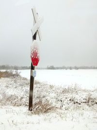 Scenic view of snow covered land against sky