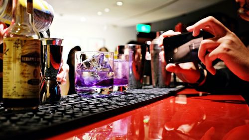 Take a shot of a purple cocktail