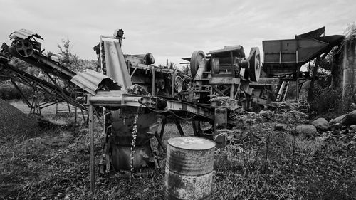 Abandoned truck on field against sky