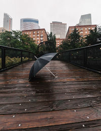 Walkway in city against sky