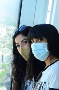 Two young sisters wearing face mask due to covid-19