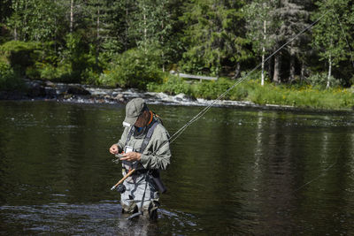 Man fishing in river