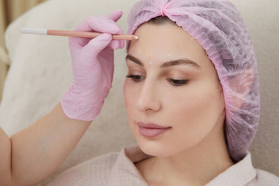 Close-up of woman applying make-up