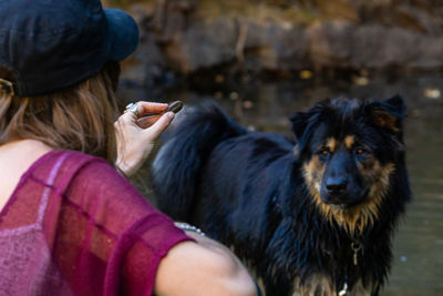 Close-up of woman feeding dog outdoors