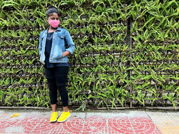 Full length of young woman standing on street