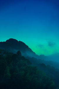 Scenic view of mountains against blue sky