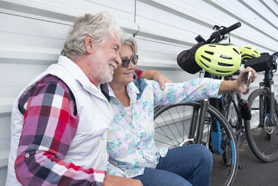 Man and woman sitting on bicycle