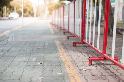 Empty footpath by street in city