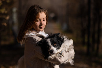 Portrait of young woman with dog