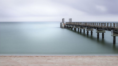 Pier over sea against sky