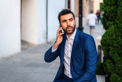 Mid adult man using mobile phone