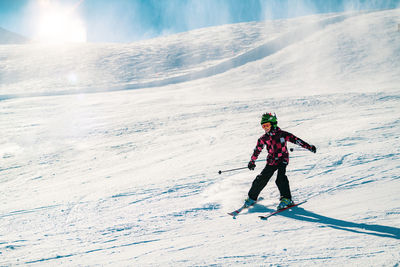 Full length of person skiing on snowcapped mountain