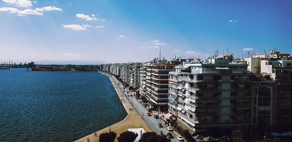 High angle view of buildings and sea against sky