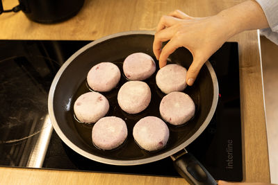 Cottage cheese pancakes fried in a pan, frozen food, semi-finished products