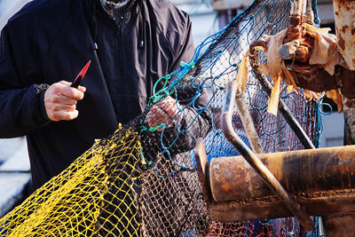Front view of person holding fishing net in hand