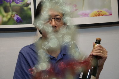 Portrait of man holding glass window