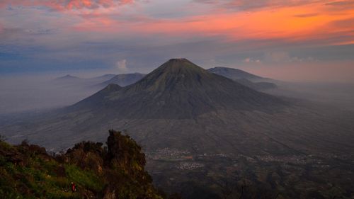 Scenic view of volcanic landscape against sky during sunset