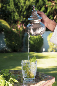 Hand holding glass of water