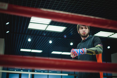 Low angle view of male boxer in boxing ring