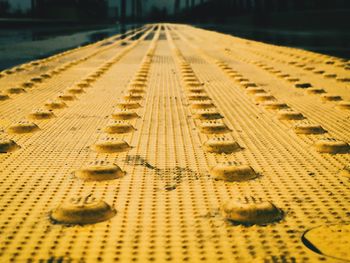 Surface level shot of yellow footpath in city