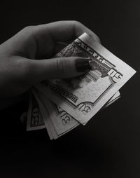 Cropped hand holding paper currencies