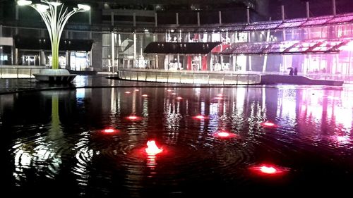 Reflection of illuminated lights on water at night