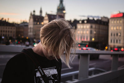 Woman standing in city at night