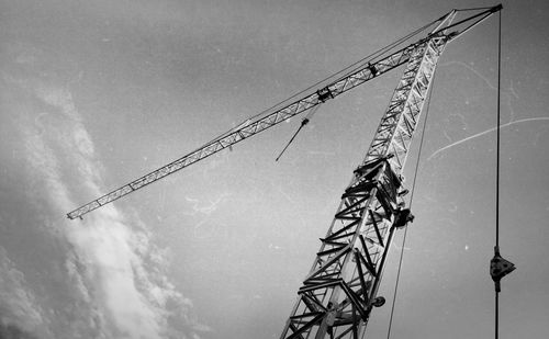 Low angle view of crane against sky