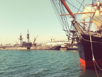 Ship moored at harbor against sky