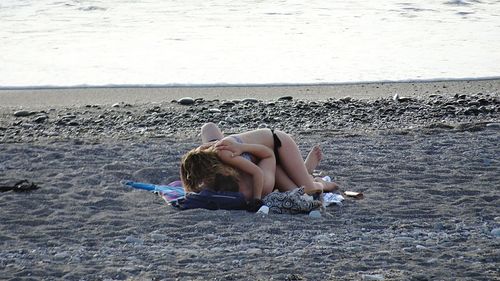 Young woman sitting on beach