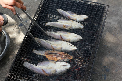 High angle view of fish on barbecue grill