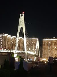 View of illuminated buildings against sky at night